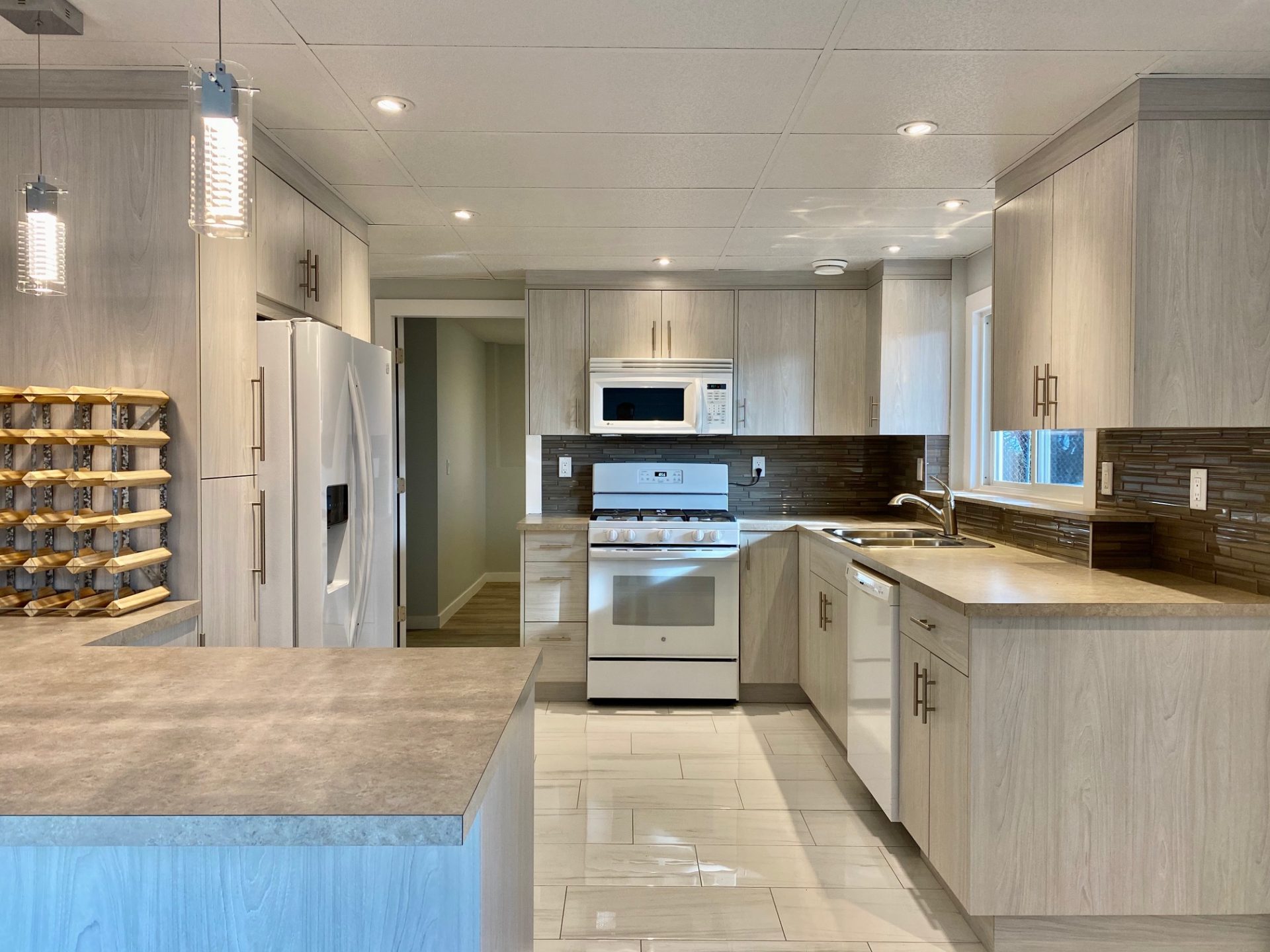 Decorative Photo Of modern, new Kitchen with grain cabinets and counter tops and new appliances.