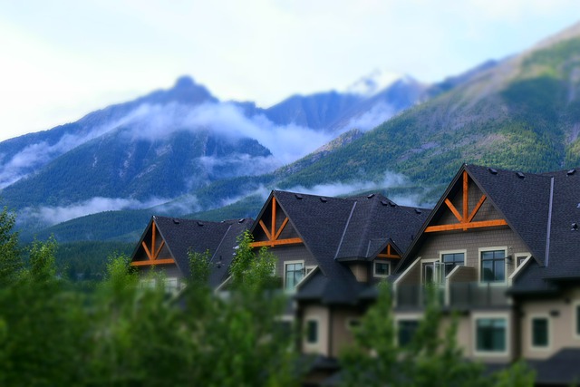 Three similar beautiful houses with a sceinic background of loud covered mountains. Vantage West Property Management can provide property management for a property like this in Kelowna BC and the Okanagan