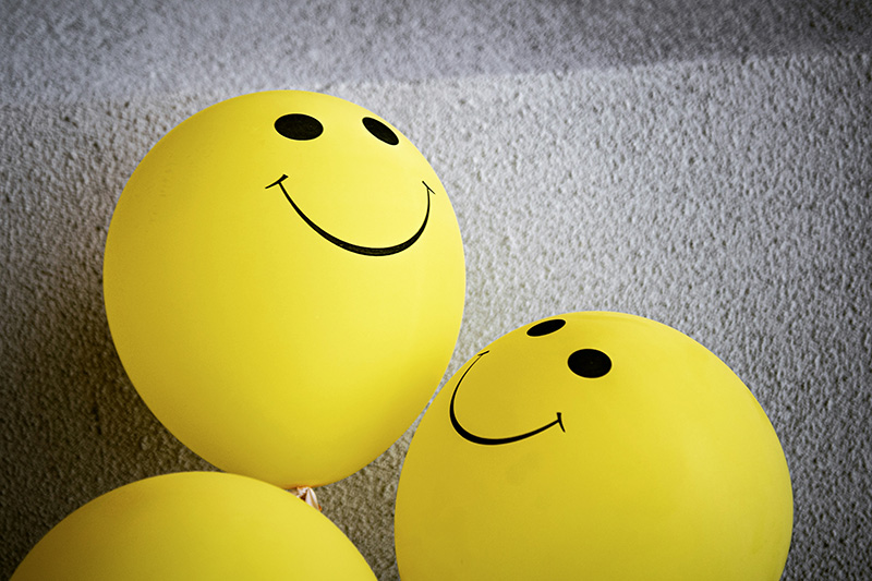 3 yellow balloons with smiley faces