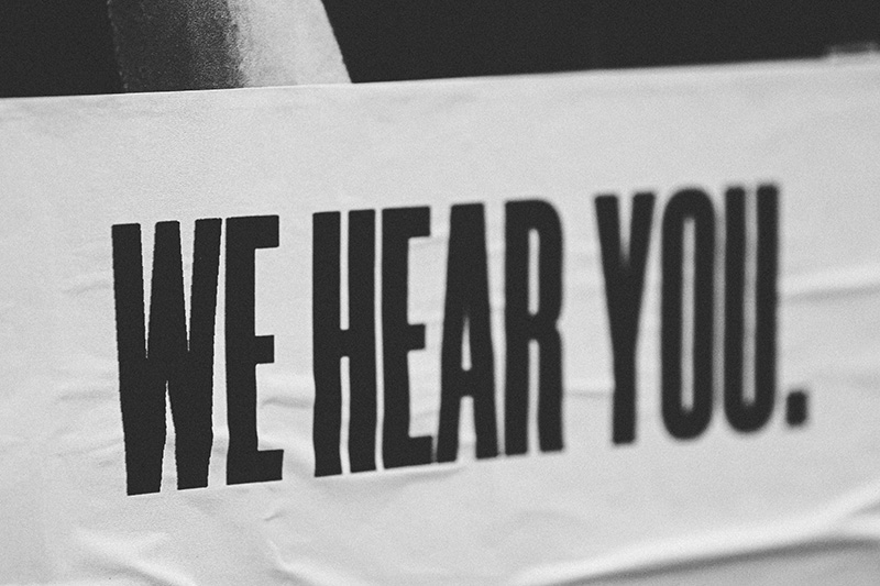 A poster that says "we hear you"