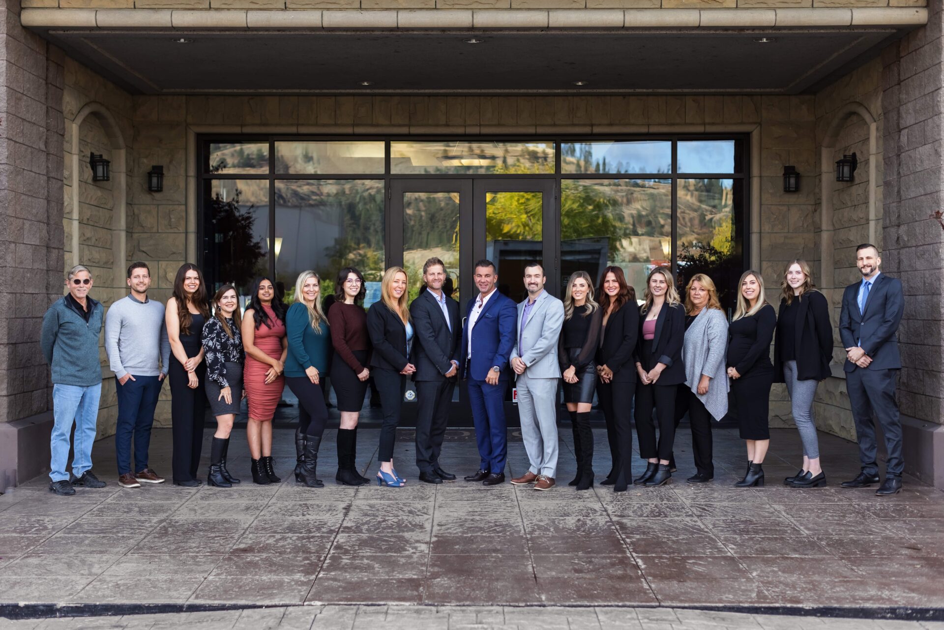 The team at Vantage West Property Management standing for a photo in front of their company building.