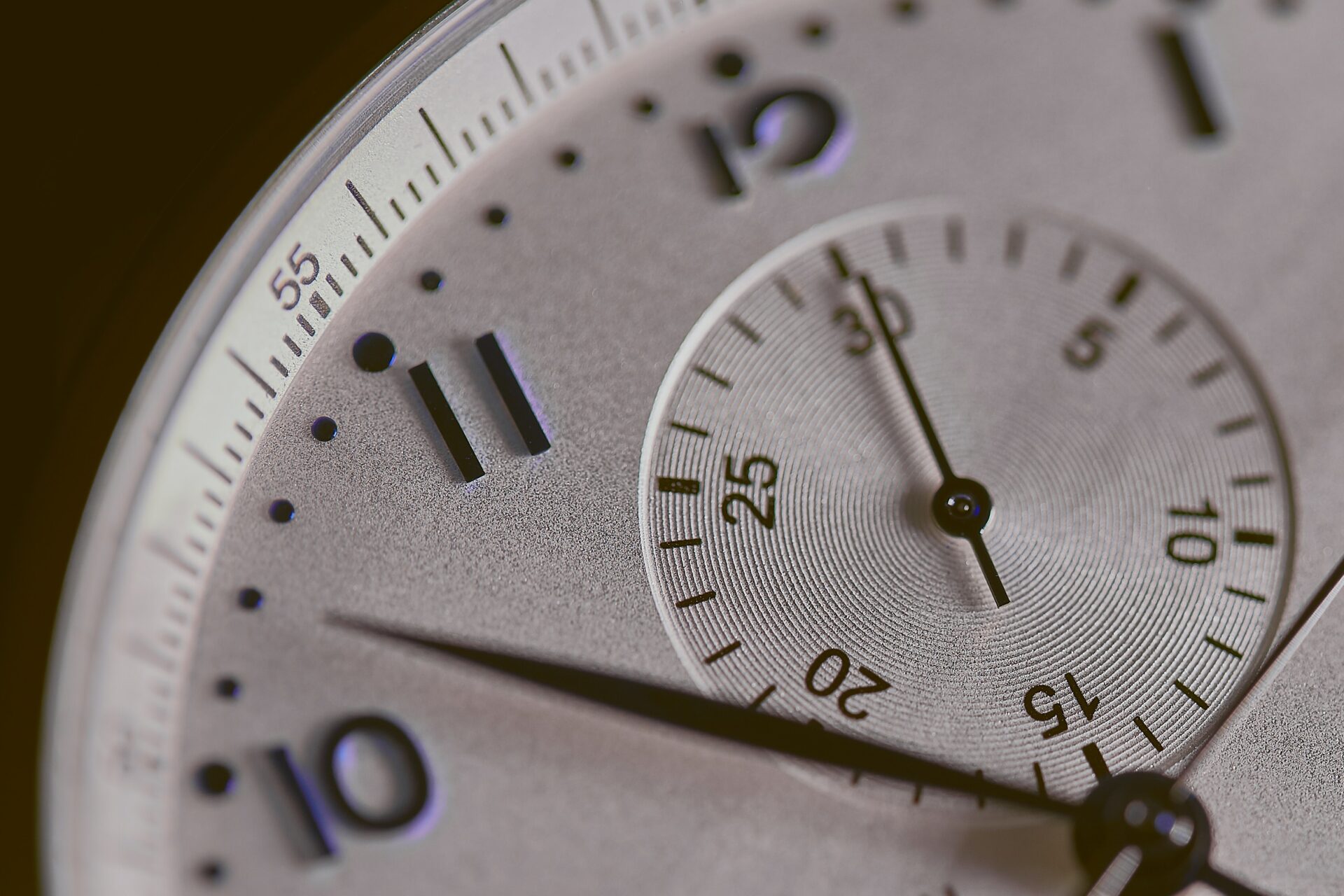 A close up of a clock's face with the minute hand just after 10 to indicate timely communication. 