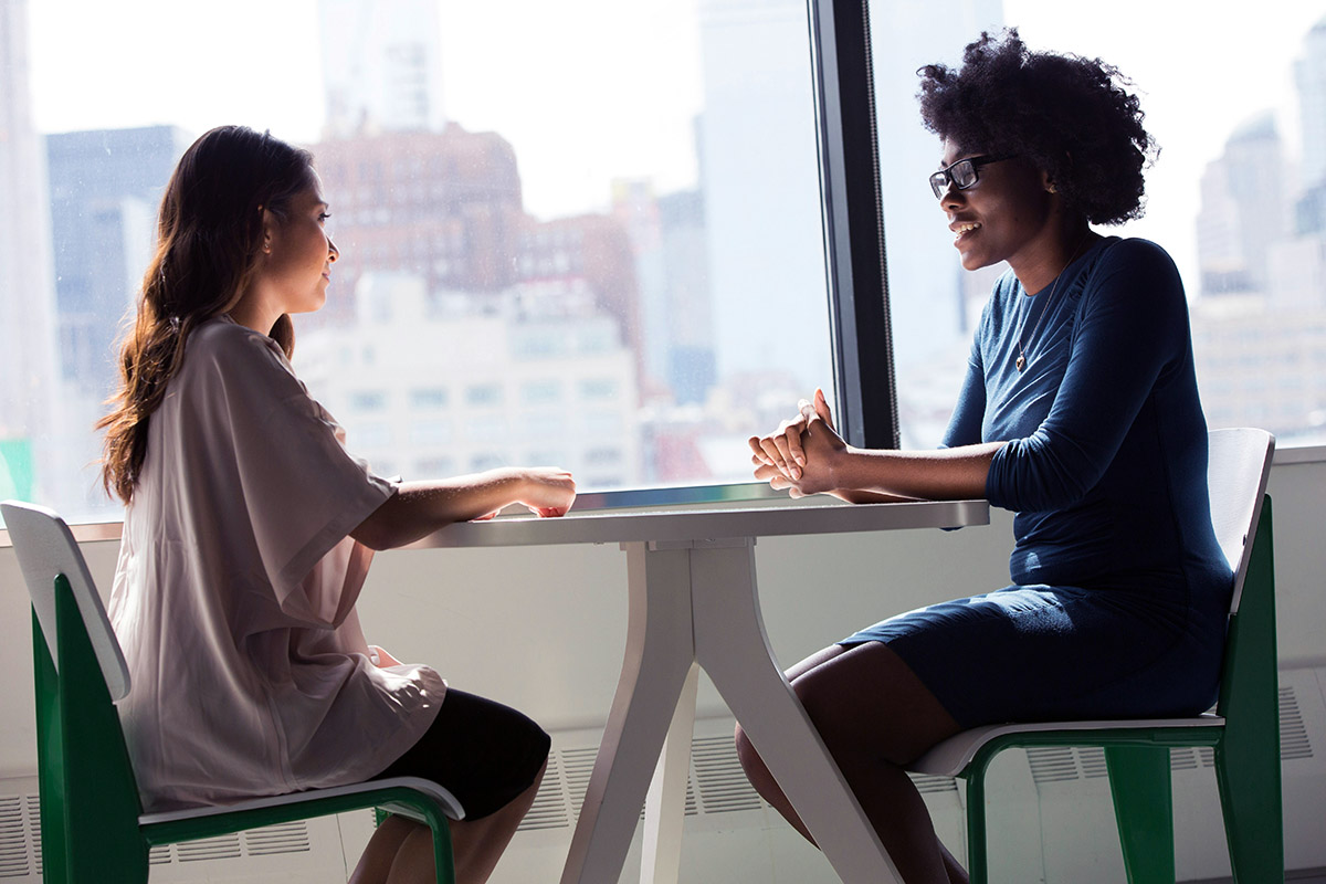 Two women sitting at a table for a tenant screening interview